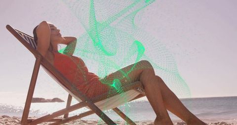 Woman relaxing on beach chair in red swimsuit with abstract green digital overlay