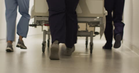 Medical Professionals Rush Undisclosed Situation in Hushed Corridor