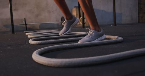 Athlete Stepping Over Ropes for Gym Training Workout Concept