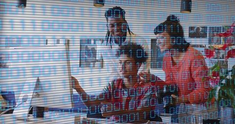 Multicultural team collaborating on code with binary data overlay for tech startup office