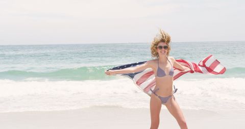 Carefree Woman with American Flag on Sunny Beach - Download Free Stock Images Pikwizard.com