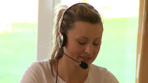 Young Woman Using Headset for Remote Communication