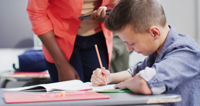 Student Focused on Homework with Teacher Assistance - Download Free Stock Images Pikwizard.com