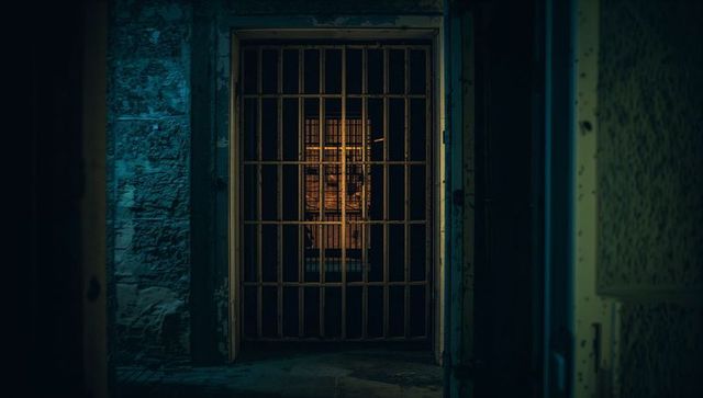 Industrial Prison Cell with Secluded Interior and Dark Ambiance