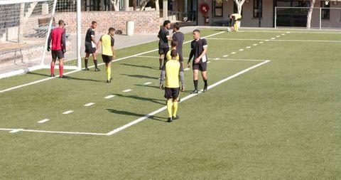 Soccer players in before match briefing on sunny field