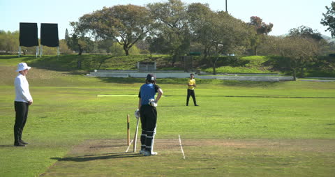 Cricket Player Preparing for Delivery on Sunny Day