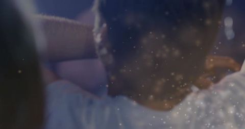 Cinematic trio relaxing on sofa with drifting light particles and cozy film mood