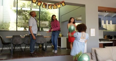 Diverse Friends Setting Up House-Warming Party Decorations