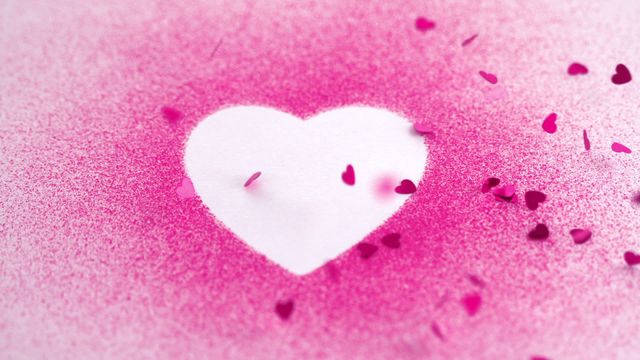 Pink heart-shaped confetti falling on a white heart background can be used for Valentine's Day greetings, romantic social media posts, wedding invitations, and celebration announcements. It conveys themes of love and affection.