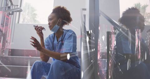 African American Doctor in Scrubs Analyzing Digital Connections