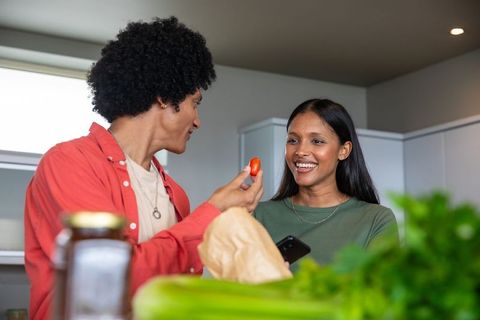Smiling Couple Enjoying Fresh Tomato Prep at Home