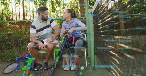 Mixed-ability tennis players chatting on bench after match, wheelchair adaptive sports