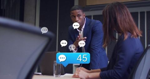 Business leader presenting strategy in boardroom while team getting 45 chat notifications
