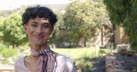 Man Enjoying Sunny Day in Vibrant Outdoor Garden Setting