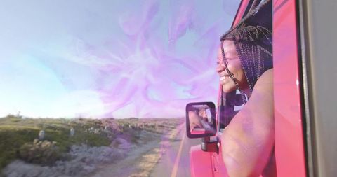 Joyful Woman Enjoying Road Trip in Red Off-Road Vehicle