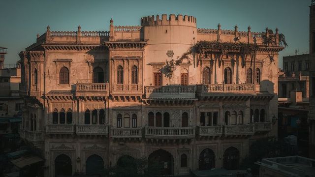 Ornate historic building facade with turret and vines