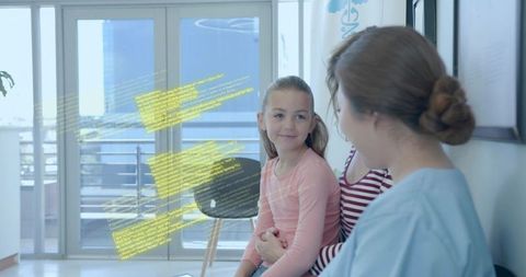 Pediatric clinician explaining care to mother and smiling child in modern clinic lobby