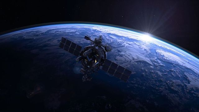 Orbiting Satellite Capturing Sun Flare Over Curved Earth Limb With Solar Arrays and Antennae