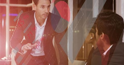 Businessman Leading Data Presentation in Modern Office