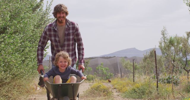 Father Enjoying Wheelbarrow Ride with Happy Child in Countryside - Download Free Stock Images Pikwizard.com