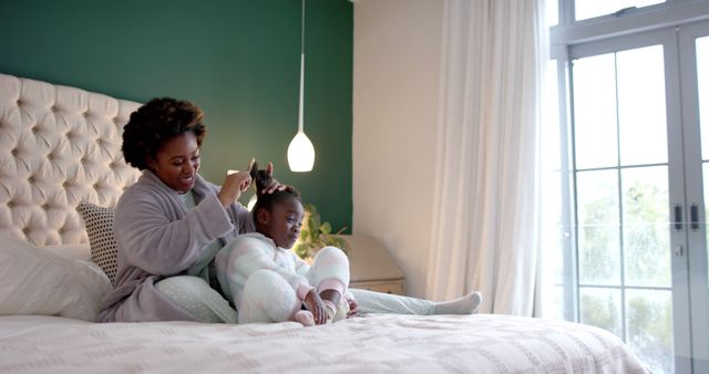 Loving Mother Styling Her Daughter's Hair in Cozy Bedroom - Download Free Stock Images Pikwizard.com