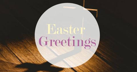 Easter greetings overlaid on wooden cross shadow