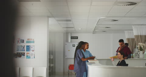 Diverse Medical Team Engaged in Discussion at Hospital Reception