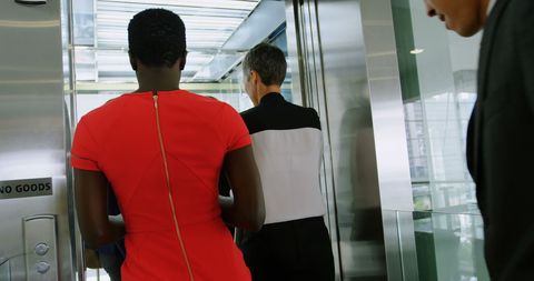 Diverse professionals standing inside elevator