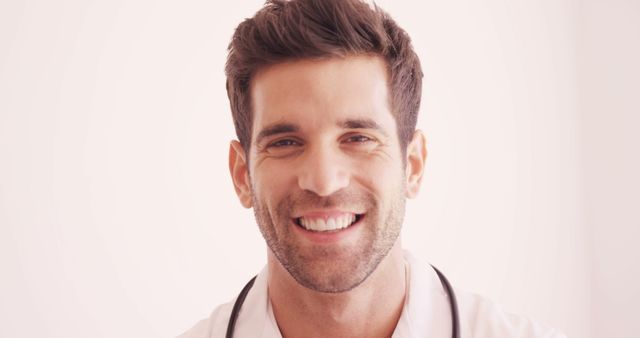 Friendly Male Doctor Smiling at Camera in Medical Office - Download Free Stock Images Pikwizard.com