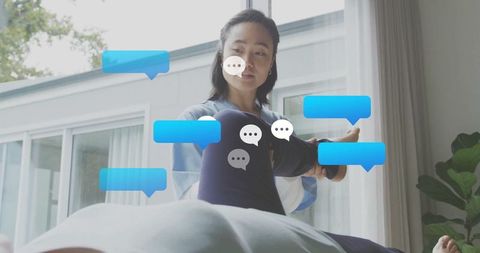 Physiotherapist assisting client stretching leg at clinic