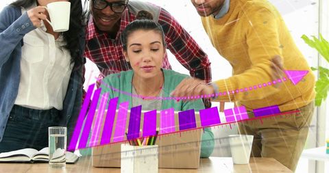 Diverse Team Discussing Business Data on Laptop in Modern Office