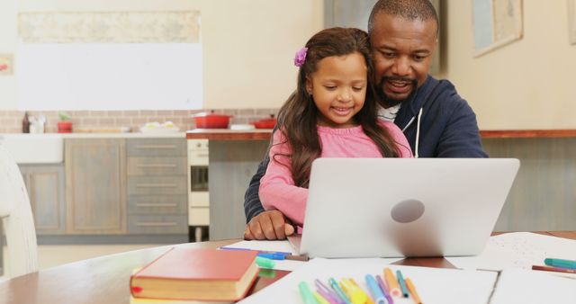 Father and daughter learning together at home using a laptop - Download Free Stock Images Pikwizard.com