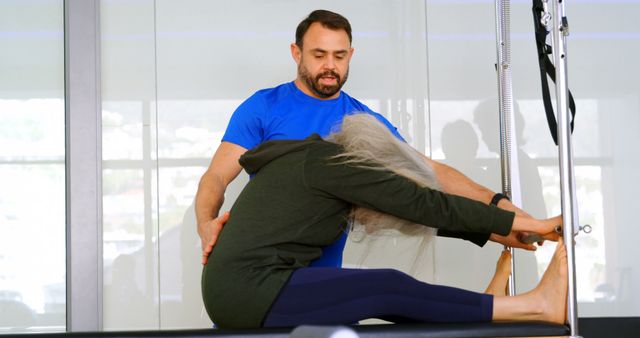 Physical Therapist Assisting Senior Woman with Pilates Stretch - Download Free Stock Images Pikwizard.com