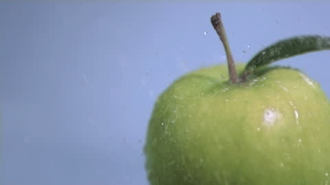 Fresh Green Apple Splashing in Slow Motion