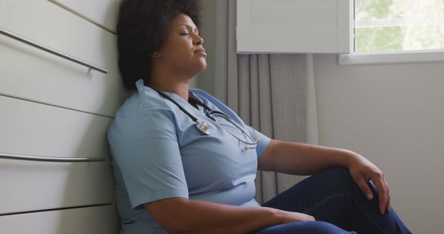 Exhausted Nurse Taking a Break Against Hospital Wall - Download Free Stock Images Pikwizard.com