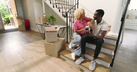 Happy Couple Enjoying New Home with Smartphone