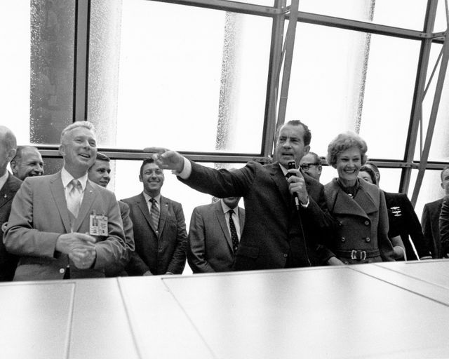 CAPE CANAVERAL, Fla. -- At the Kennedy Space Center in Florida, President Richard M. Nixon speaks in the Launch Control Center after the successful liftoff of the Apollo 12 space vehicle, which sent astronauts Charles Conrad, Jr., Richard F. Gordon and Alan Bean on the first leg of their lunar landing mission. With the President are Paul Donnelly, Launch Operations manager, on the left, and First Lady Pat Nixon, on the right. Photo Credit: NASA