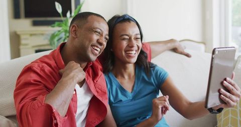 Happy Couple Having Video Call on Smartphone at Home