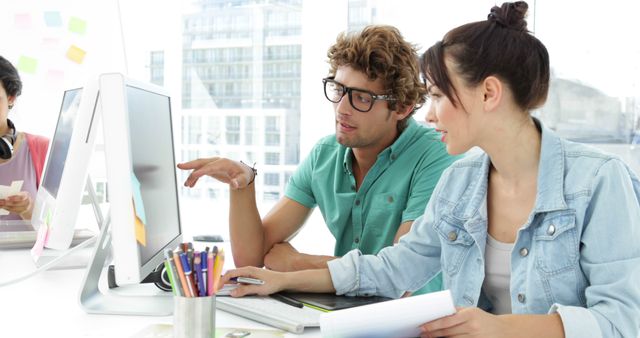 Young Colleagues Discussing a Project in a Modern Office - Download Free Stock Images Pikwizard.com