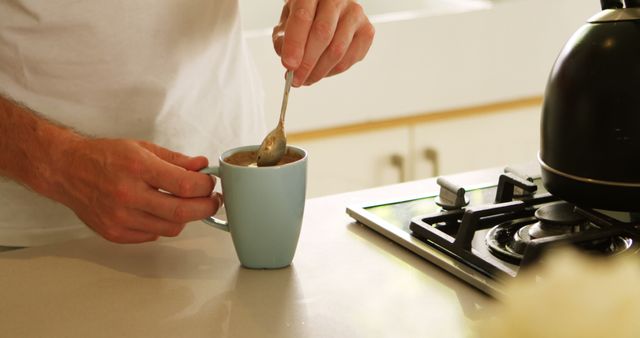 Man Stirring Coffee in the Morning Kitchen - Download Free Stock Images Pikwizard.com