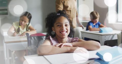 Smiling Biracial Girl in Diverse Classroom with White Bokeh Overlay