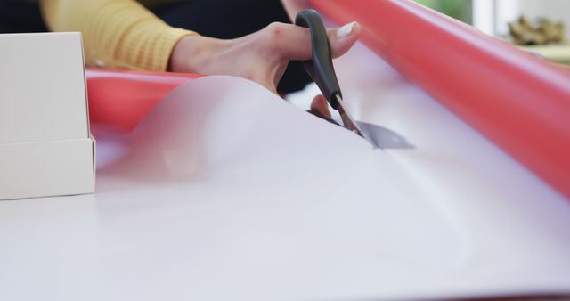 Person Cutting Red Wrapping Paper with Scissors - Download Free Stock Images Pikwizard.com