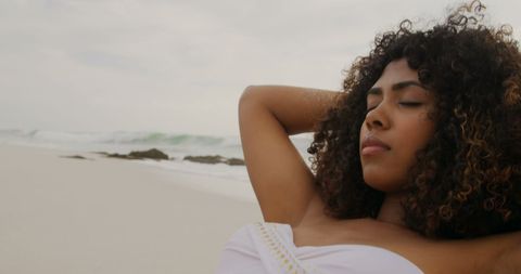 Relaxing African American Woman Reclining on Beach