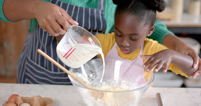 Parent and Child Baking Together in Kitchen, Pouring Milk into Mixing Bowl - Download Free Stock Images Pikwizard.com