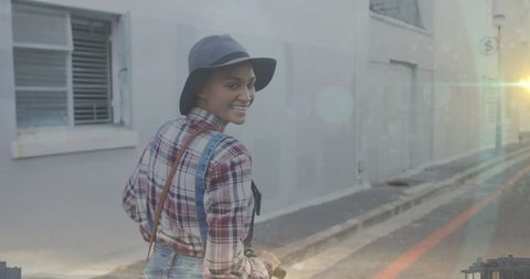 Smiling Woman Riding Scooter on Urban Street