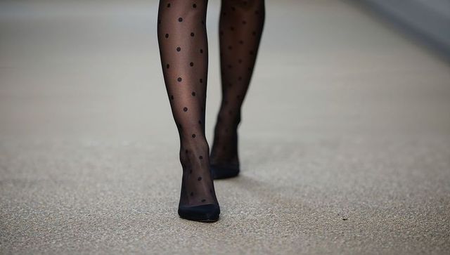 Street style closeup walking in sheer black polka-dot tights and pointed heels