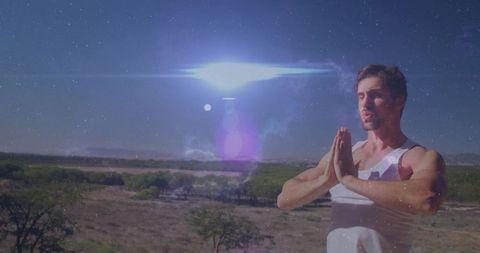 Man Practicing Mindfulness in Tranquil Desert Landscape Under Sky