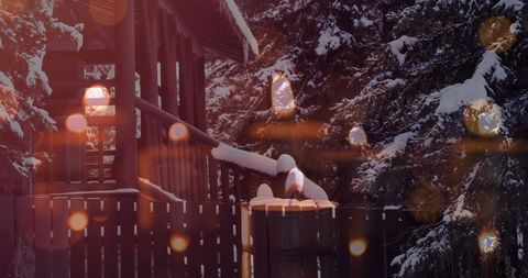 Cozy Snow-Covered Cabin with Warm Glowing Lights at Dusk