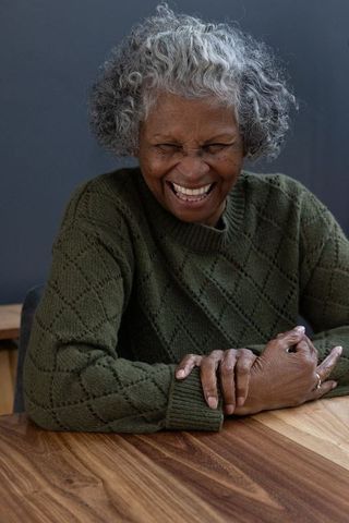 Joyful Senior African American Woman Laughing at Home