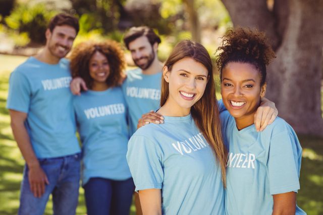 Group of diverse volunteers smiling and enjoying time together in a park. Ideal for use in community service promotions, charity event advertisements, social work campaigns, and teamwork illustrations.